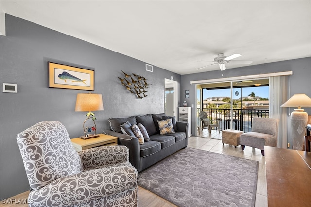 living area featuring a ceiling fan and visible vents