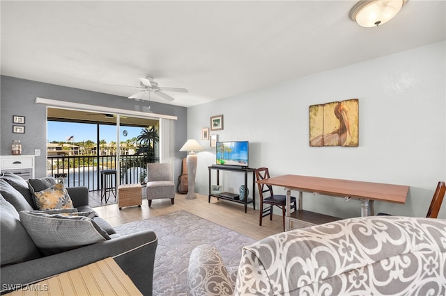 living room featuring wood finished floors and a ceiling fan