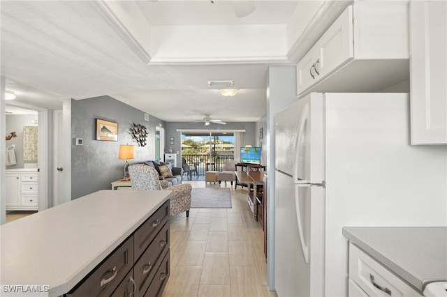 kitchen with visible vents, freestanding refrigerator, ceiling fan, light countertops, and white cabinetry