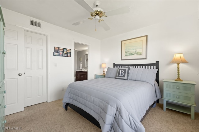 bedroom featuring a ceiling fan, ensuite bath, carpet, and visible vents