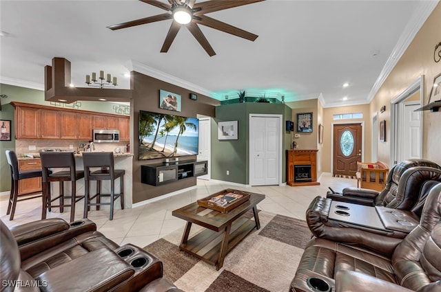 living area with light tile patterned floors, crown molding, and a ceiling fan