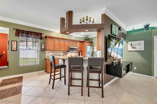 kitchen featuring baseboards, tasteful backsplash, appliances with stainless steel finishes, and light tile patterned flooring