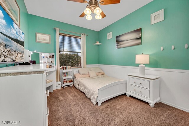 bedroom with carpet flooring, wainscoting, and ceiling fan