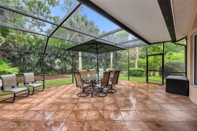 view of patio / terrace with glass enclosure and outdoor dining area