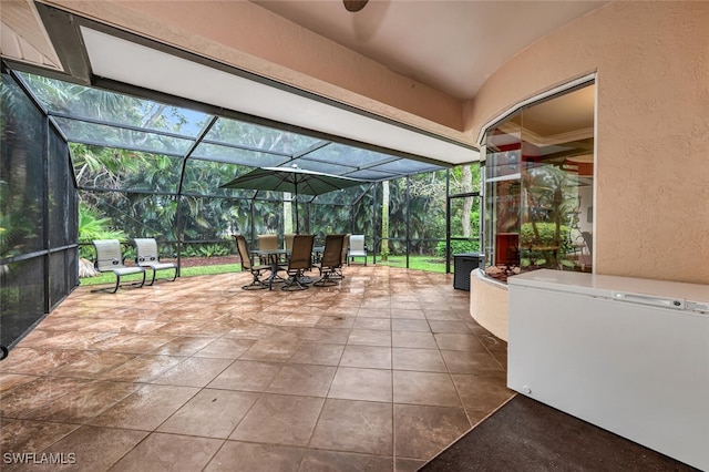 view of patio featuring glass enclosure and outdoor dining area