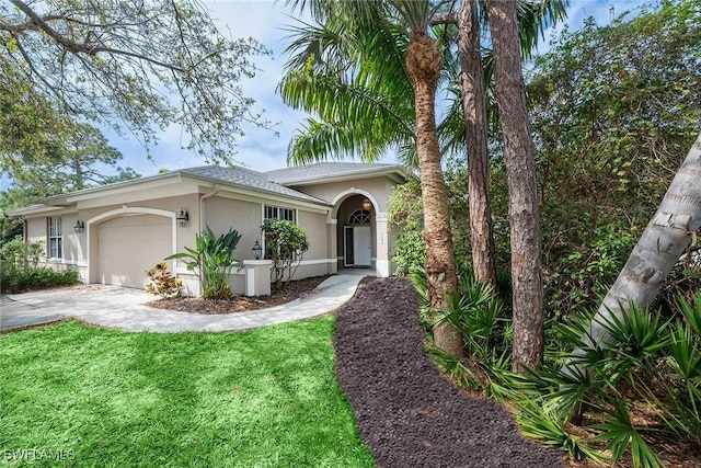 single story home with stucco siding, driveway, a front lawn, and a garage