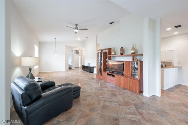 living area with a ceiling fan, visible vents, baseboards, lofted ceiling, and recessed lighting