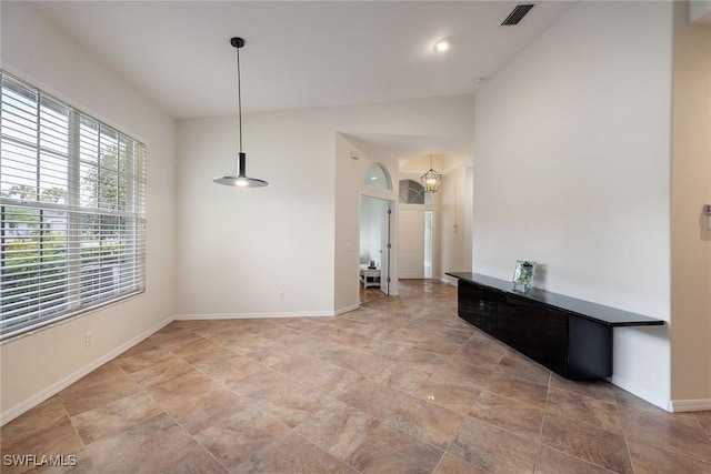 interior space featuring visible vents, lofted ceiling, and baseboards