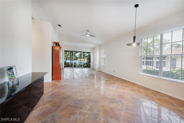 spare room with a wealth of natural light, baseboards, and a ceiling fan