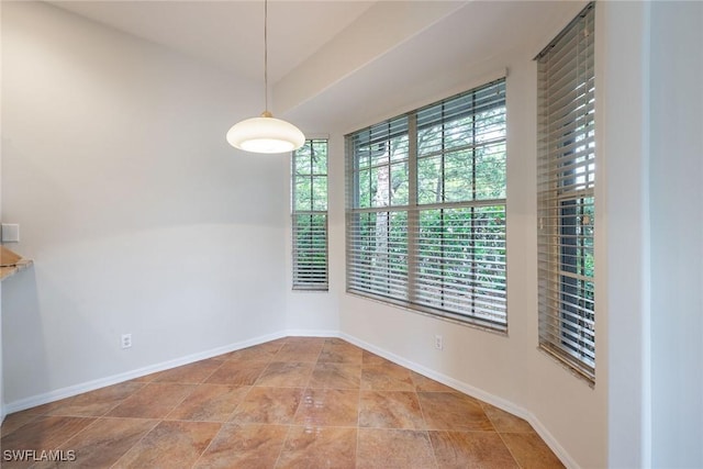 empty room featuring baseboards