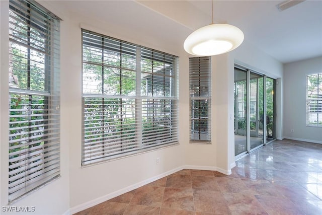 unfurnished dining area with baseboards