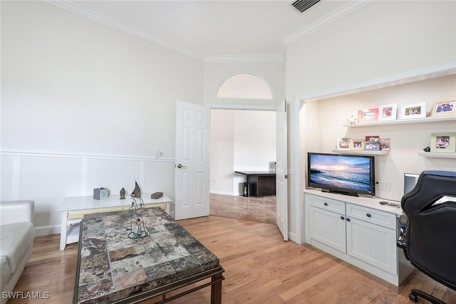 interior space with visible vents, light wood finished floors, and ornamental molding