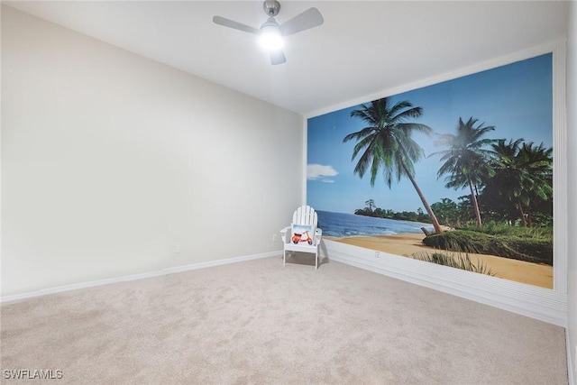 carpeted spare room with ceiling fan and baseboards