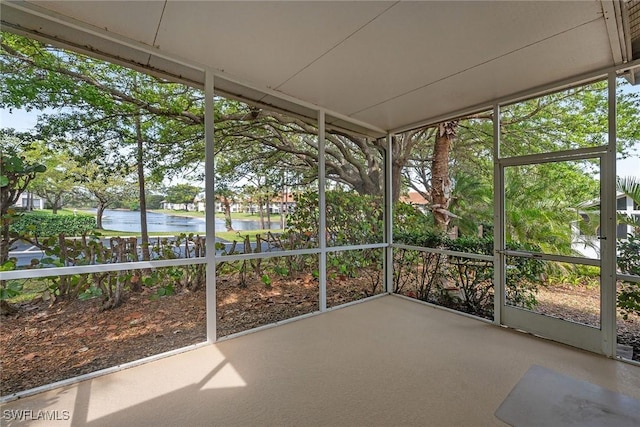 unfurnished sunroom with a water view