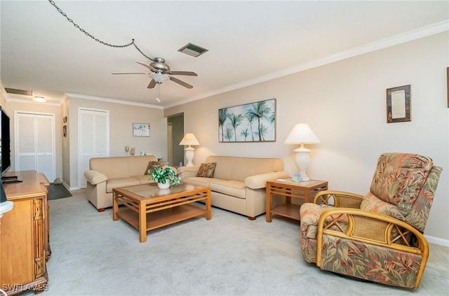 living room featuring crown molding, light carpet, ceiling fan, and baseboards