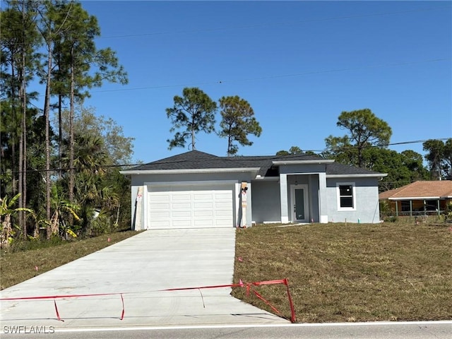 view of front facade with a front lawn, a garage, driveway, and stucco siding