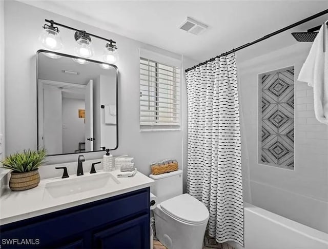 full bath with vanity, shower / tub combo, toilet, and visible vents