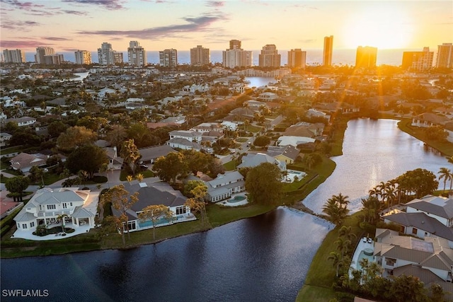 drone / aerial view featuring a view of city and a water view