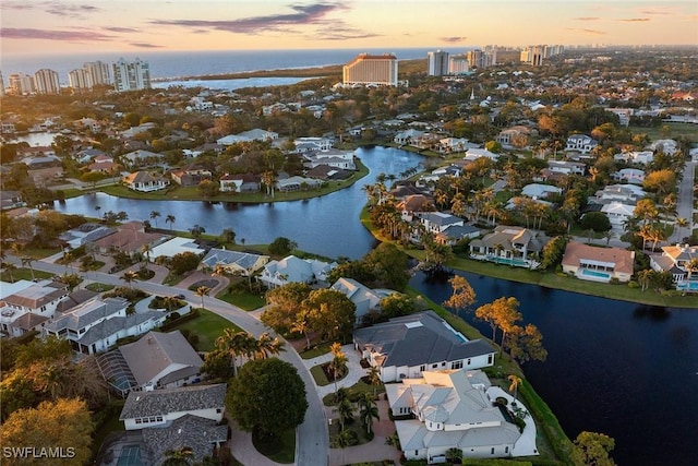 drone / aerial view with a residential view and a water view