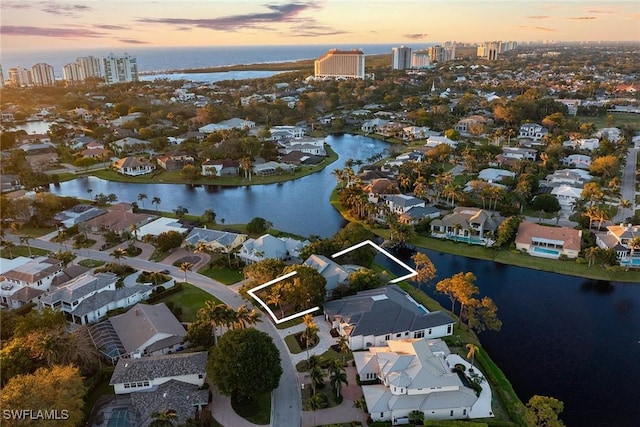 birds eye view of property with a residential view and a water view