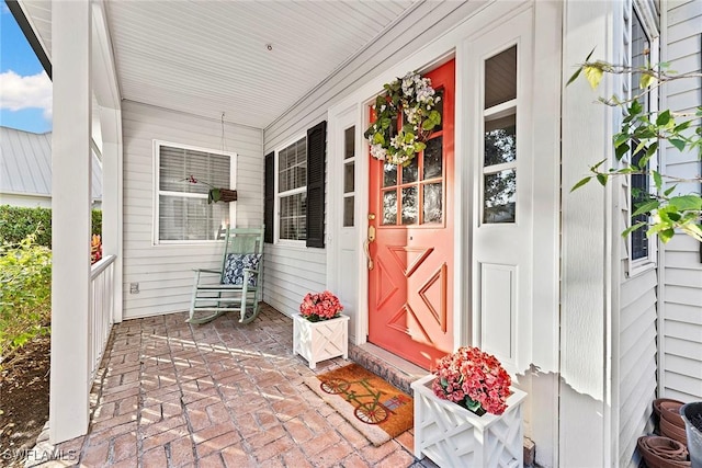 view of exterior entry with covered porch