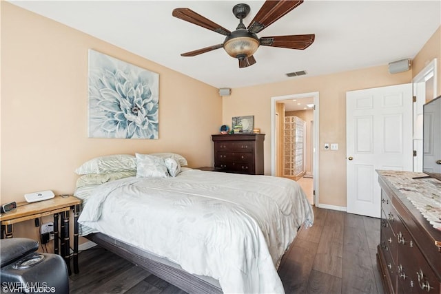 bedroom featuring a ceiling fan, dark wood-type flooring, baseboards, and visible vents