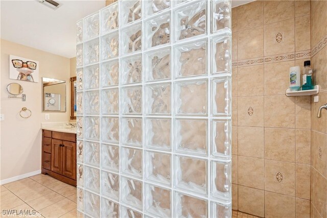 bathroom featuring visible vents, vanity, tile patterned flooring, and a walk in shower