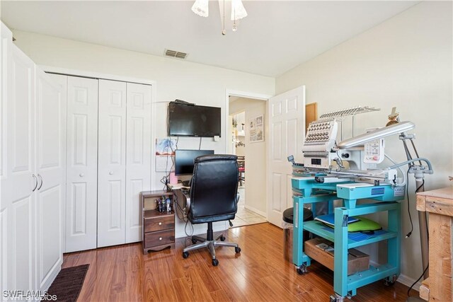 office area featuring visible vents and wood finished floors