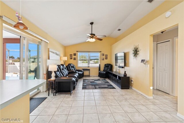 living area featuring visible vents, light tile patterned flooring, a ceiling fan, and vaulted ceiling