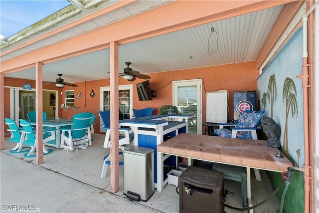 view of patio / terrace with outdoor dining area and a ceiling fan