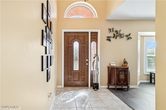 entrance foyer featuring light tile patterned flooring and baseboards