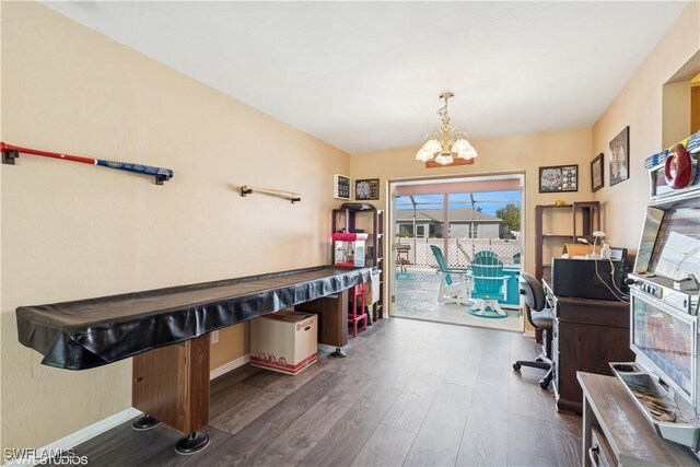 office area with a chandelier, baseboards, and wood finished floors