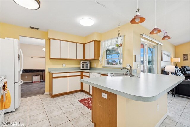 kitchen with white appliances, visible vents, a sink, light countertops, and open floor plan