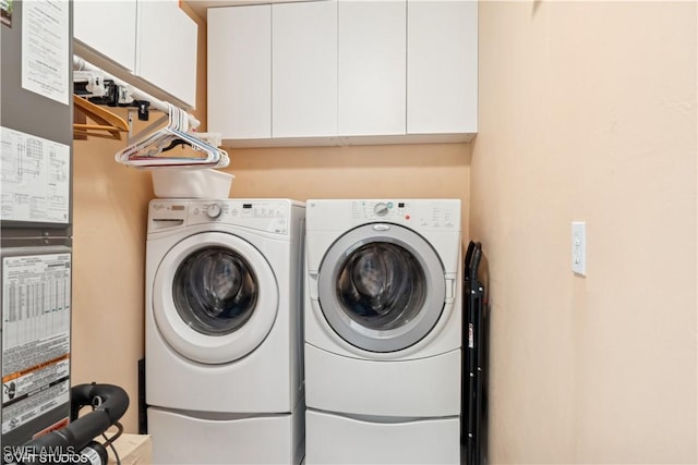 laundry area with cabinet space and separate washer and dryer