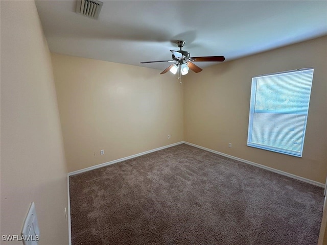 unfurnished room featuring a ceiling fan, carpet, visible vents, and baseboards