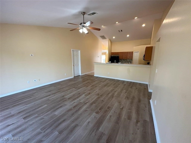 unfurnished living room with wood finished floors, visible vents, and baseboards