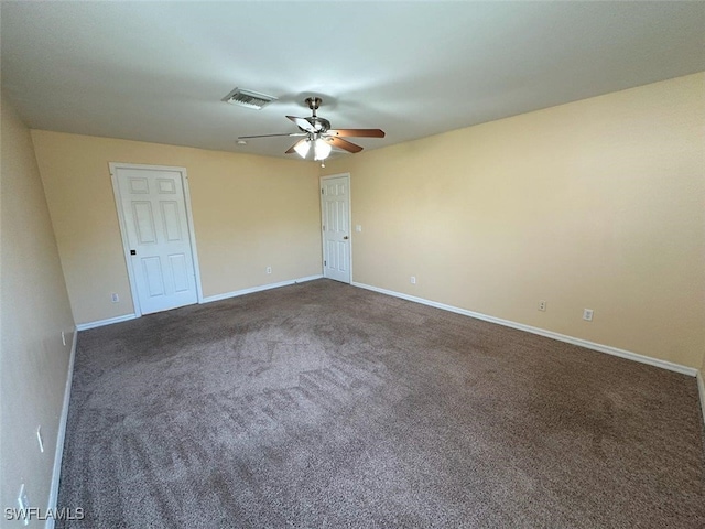 spare room with visible vents, carpet floors, baseboards, and a ceiling fan