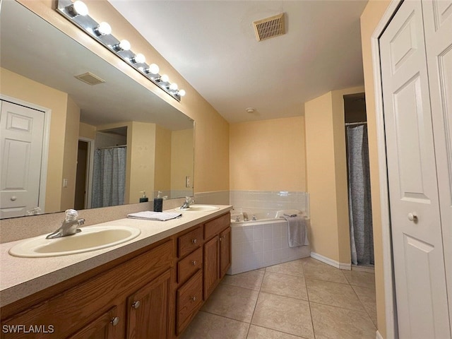 bathroom featuring a sink, visible vents, and tile patterned floors