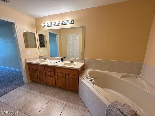 full bath featuring double vanity, a bath, visible vents, and a sink