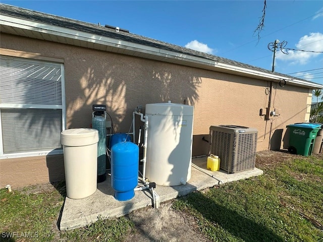 view of property exterior with stucco siding and central AC