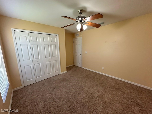 unfurnished bedroom featuring baseboards, visible vents, carpet floors, and a closet