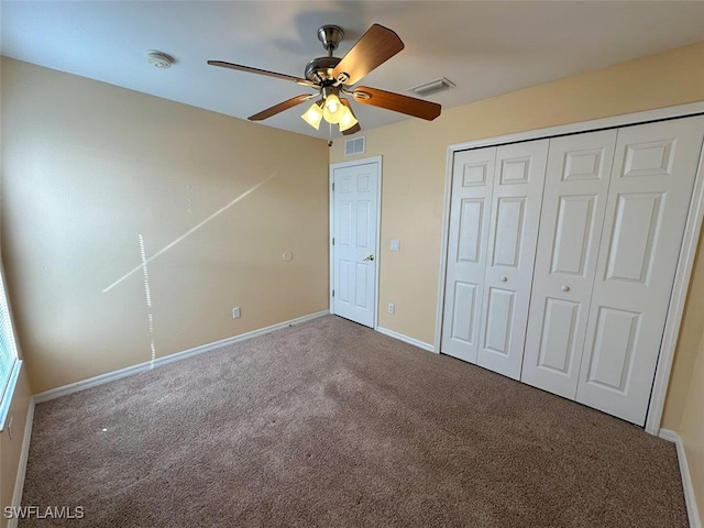 unfurnished bedroom with a closet, baseboards, visible vents, and carpet floors