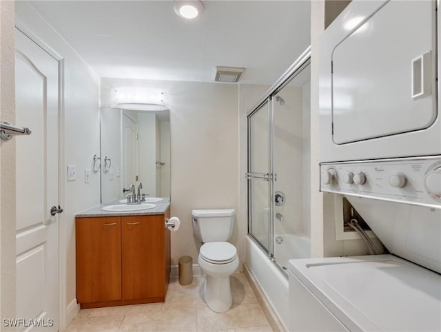 full bathroom with vanity, visible vents, tile patterned flooring, stacked washer / drying machine, and toilet