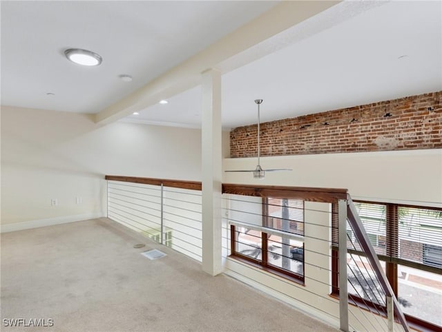 hall with beamed ceiling, baseboards, and carpet flooring