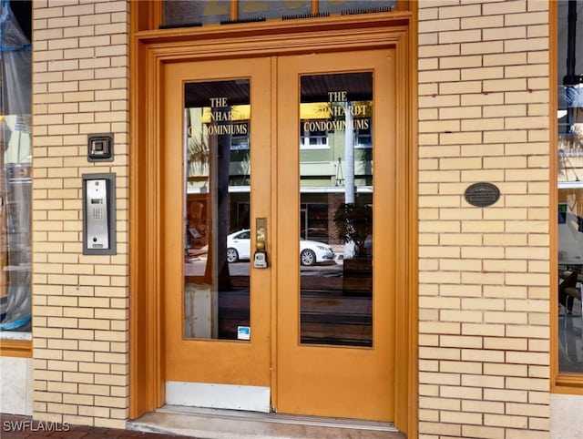 doorway to property with french doors and brick siding