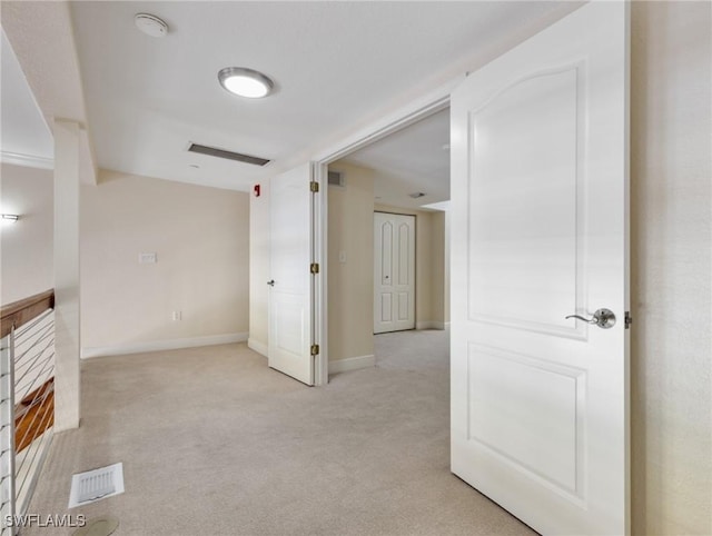 unfurnished room with visible vents, carpet floors, and baseboards