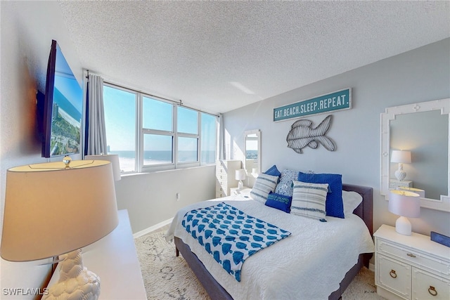 bedroom with baseboards and a textured ceiling