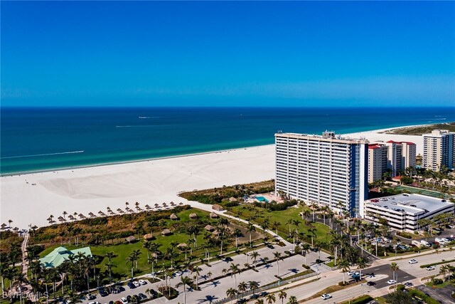 birds eye view of property with a water view and a view of the beach