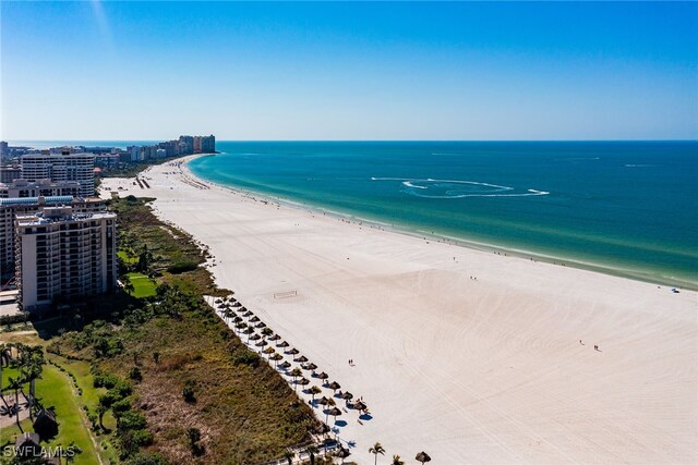 birds eye view of property featuring a beach view and a water view