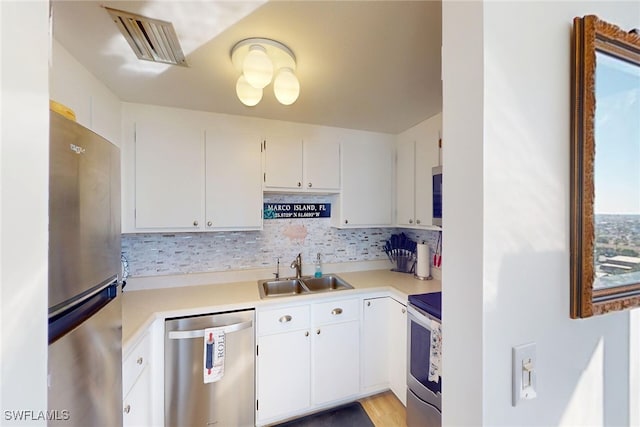 kitchen with visible vents, appliances with stainless steel finishes, light countertops, and a sink